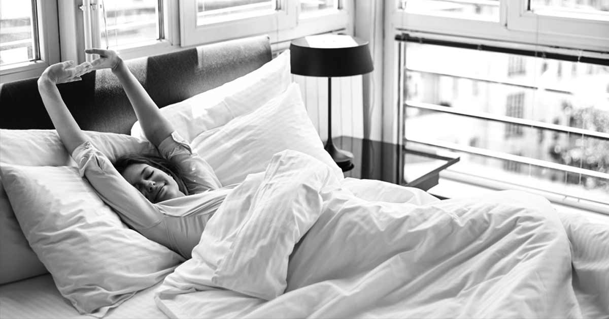 4 Stretches You Can Do In Bed To Prepare For a Busy Day
