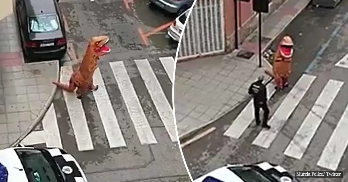 Man dressed as T-Rex runs down a street in Spain during lockdown