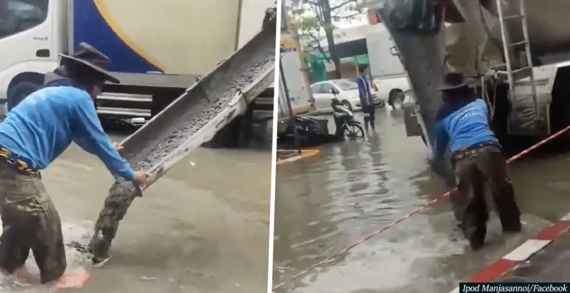 Bangkok road workers continue pouring cement amid massive flood
