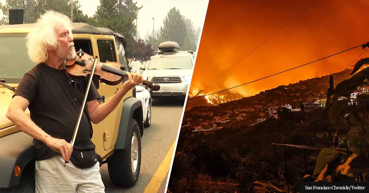 Man plays his violin amidst evacuation traffic following devastating Caldor wildfire